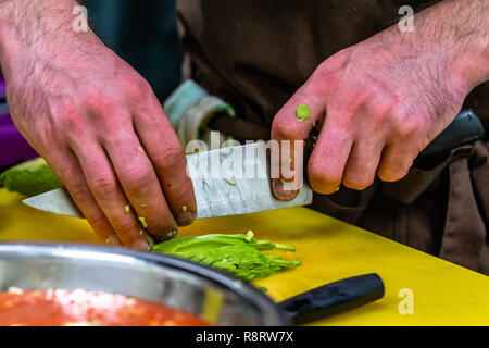 Male Chef Slicing Avocado for  Wedding Meal - Kitchen Set with Isolated Action, Only Chef`s Hands Stock Photo